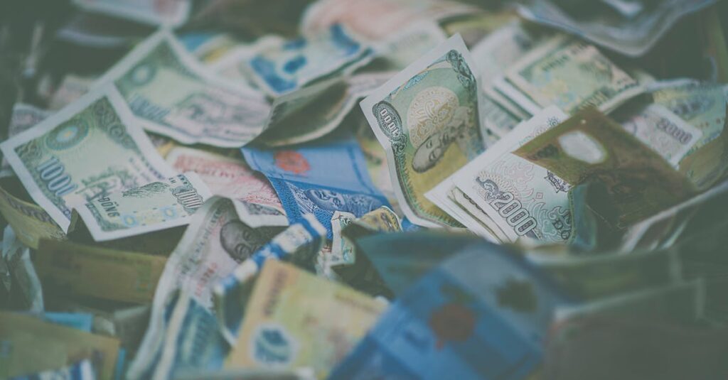 A close-up view of diverse international currency banknotes in soft focus, conveying wealth and finance themes.