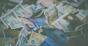 A close-up view of diverse international currency banknotes in soft focus, conveying wealth and finance themes.