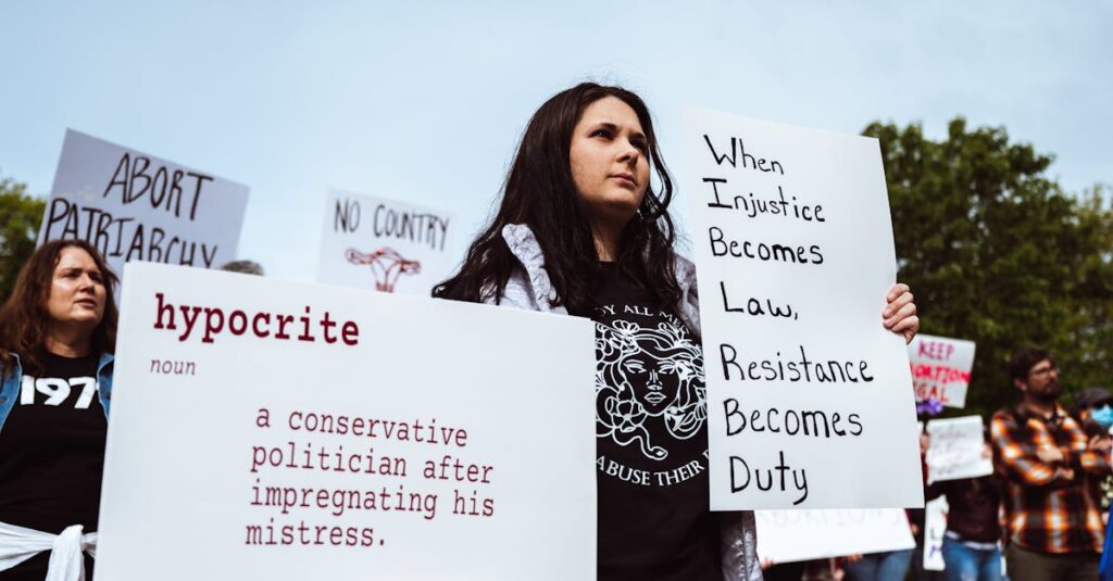 A group of protesters advocating for social justice and gender equality with impactful signs.