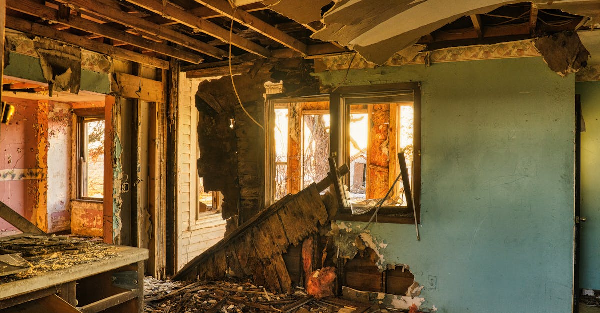 A view of a severely damaged room in an abandoned home, showcasing destruction and rubble.